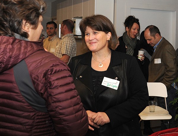 Mayor Patricia Heintzman speaks with entrepreneurs and community members following the breakfast event held Friday, Jan. 9.