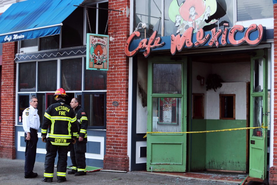 Victoria Fire investigators look over the scene of a blaze early Tuesday at Cafe Mexico in Market Square.