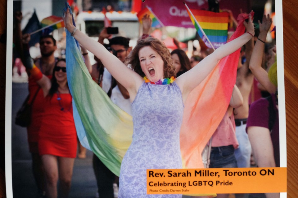 Rev. Sarah Miller, celebrating at an LGTBQ rally, was also featured in The Calendar Revs.