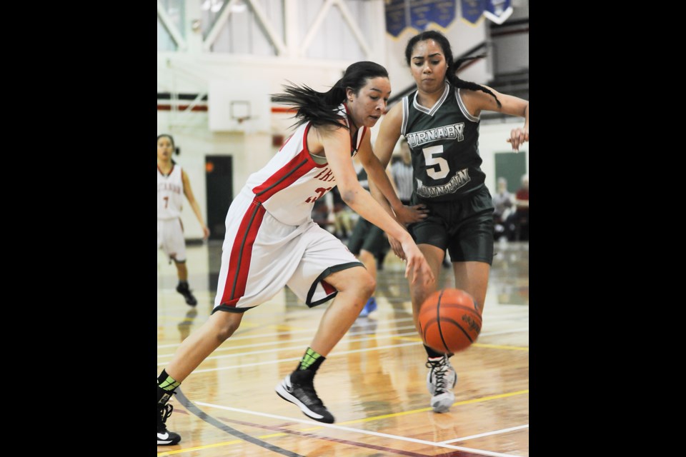 Britannia Bruin Lauren Powell charges past Burnaby Mountain’s Jacey Bailey during the final of the Britannia Invitational on Jan. 17, 2015. The Bruins won 76-58. Photo Rebecca Blissett