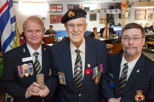 Easterbrook, centre, receives his award from, left, Dale Johnston, Peace Arch Zone Commander, and Bill Spencer, Honours and Awards Chairman, Richmond branch of the Royal Canadian Legion.