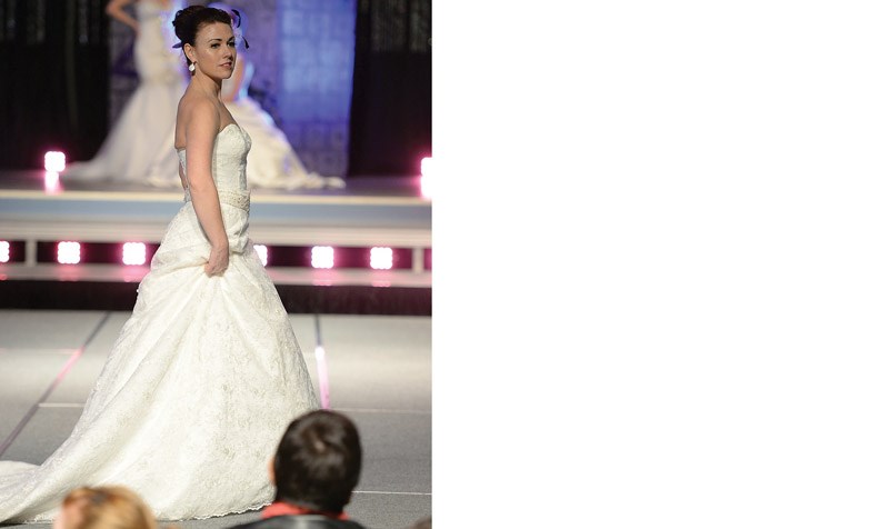 Kristen Helfrich wears a dress from Image In White Wedding Gallery during the bridal fashion show at the Sweet Heart Bridal Fair in the Civic Centre Saturday.