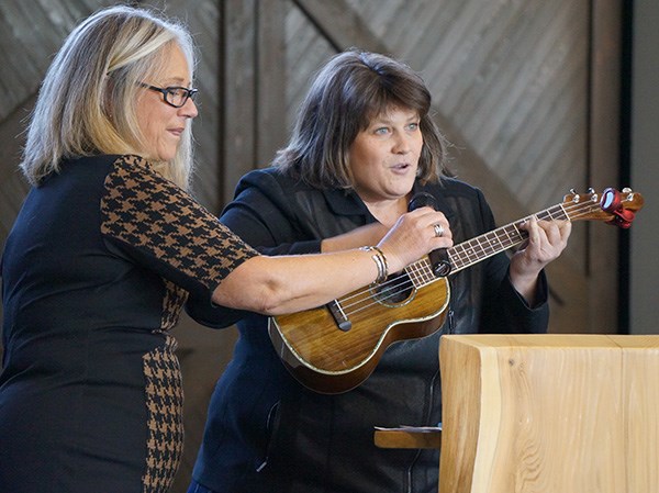 The mayor playing ukelele to kick off the luncheon.