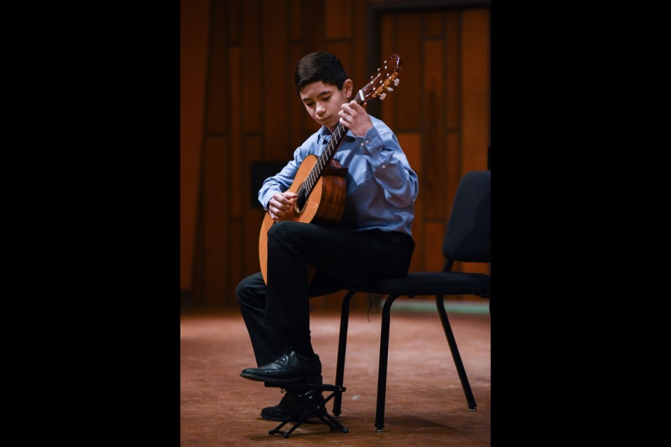 Brandon Krezeski, 14, plays “Spanish Romance” on the guitar as part of the Vancouver Academy of Music’s Strawberry & Tea recital this past Saturday. The music conservatory was part of Vanier Park’s fourth annual Winter Wander open house. Photograph by: Rebecca Blissett