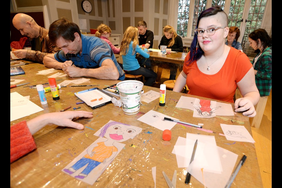 Rudi Leibik draws her daughter Lily Baker during a family Team Portrait session at Burnaby Art Gallery, part of the Family Day fun offered around the city.