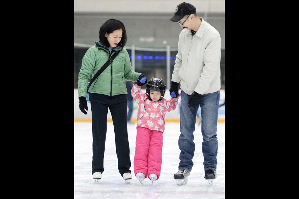 Felicia Poon, David Chan and three-year-old Olivia try out the Family Day Loonie Skate at Bill Copeland arena.