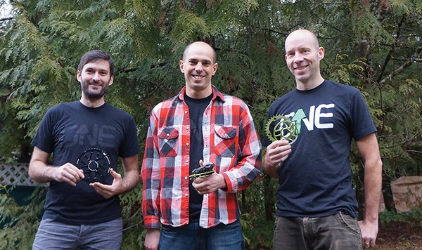 Rec-tech company OneUp’s founders Jonathan Staples, left, Sam Richards, centre, and Chris Heynen hold examples of their product. The three are engineers who launched their first product, a mountain bike sprocket and cassette that extends a bike’s gear-ratio range, about 18 months ago.