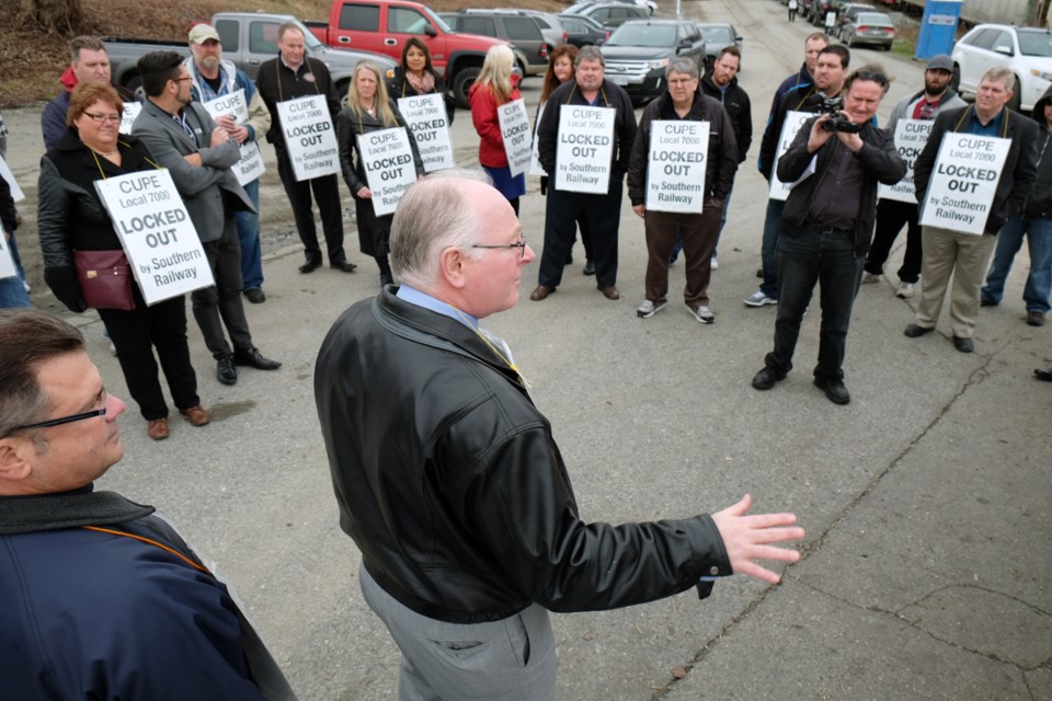 On the line: Canadian Union of Public Employees' national president Paul Moist speaks to unionized workers at Southern Railway on Wednesday. Moist and secretary-treasurer Charles Fleury - in town for meetings - turned up at the picket lines to support the workers who have been locked-out since Jan. 5.