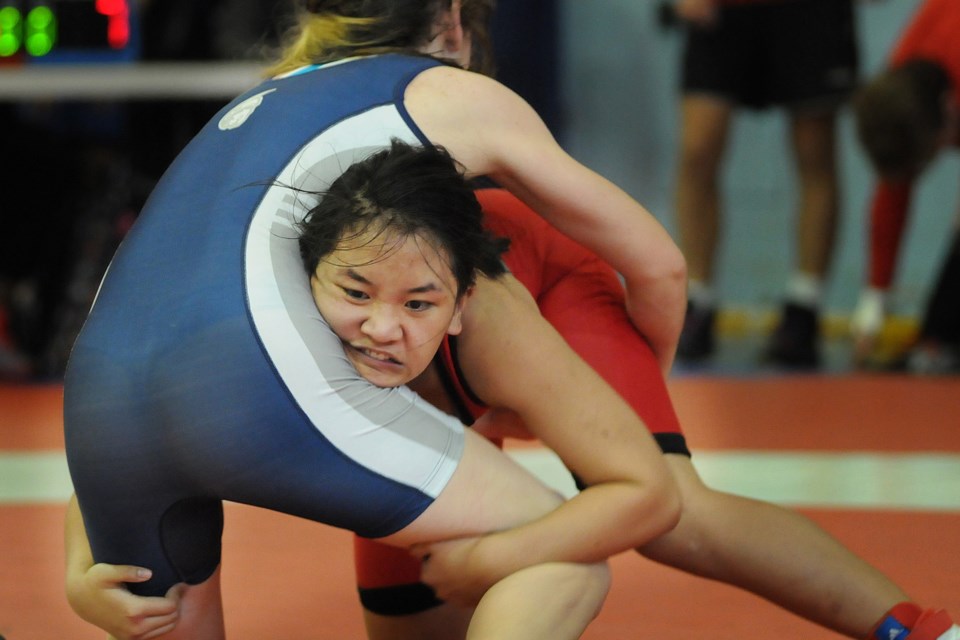 John Oliver’s Chantel Wacchan (in red) fights for position against a Sentinel secondary competitor during the Vancouver/North Shore regional meet at John Oliver secondary Feb. 13, 2015. She won bronze in the girls 54-kilogram class. Photo Dan Toulgoet
