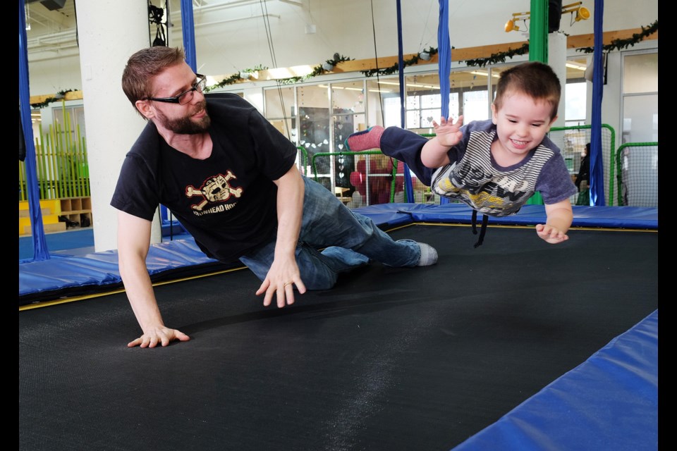 Three-and-a-half-year-old Harrison Pike and dad Adam get some air on the trampoline at Vancouver Circus School.