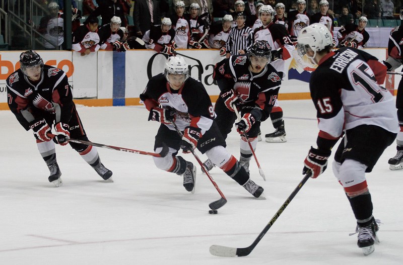 PG Cougars centre No. 9 Brad Morrison, works his way through Moose Jaw defenceman No. 7 Tyler Brown and left winger No. 13 Jiri Smejkal while Cougars left winger No. 15 Jari Erricson moves into position to support him during second period action at CN Centre Saturday night.