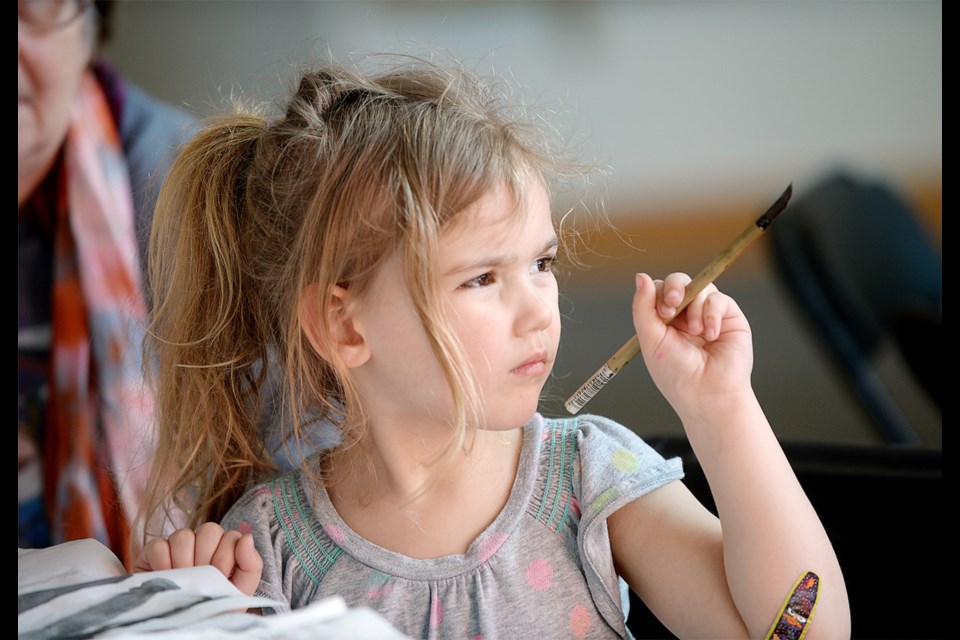 Katie Brooke, 5, is serious about her artistic efforts during a Chinese brush painting drop-in at the Shadbolt Centre for the Arts.