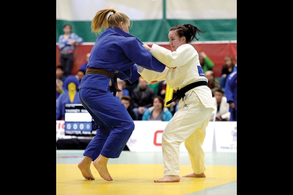 Kristen Yawney, right, from Team BC, is competing in a match against Keira Trotter from Alberta in the -70kg class Thursday at the Northern Sport Centre during the Canada Winter Games.