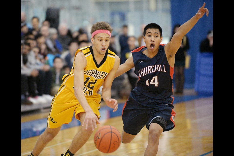 Churchill's Lambert Pajayon (No. 14) stays close to Burnaby South Rebel Tyus Batiste (No. 12) in the senior boys AAAA Lower Mainland final at the Richmond Oval on Feb. 28, 2015. Churchill won 94-84. Photo Jennifer Gauthier