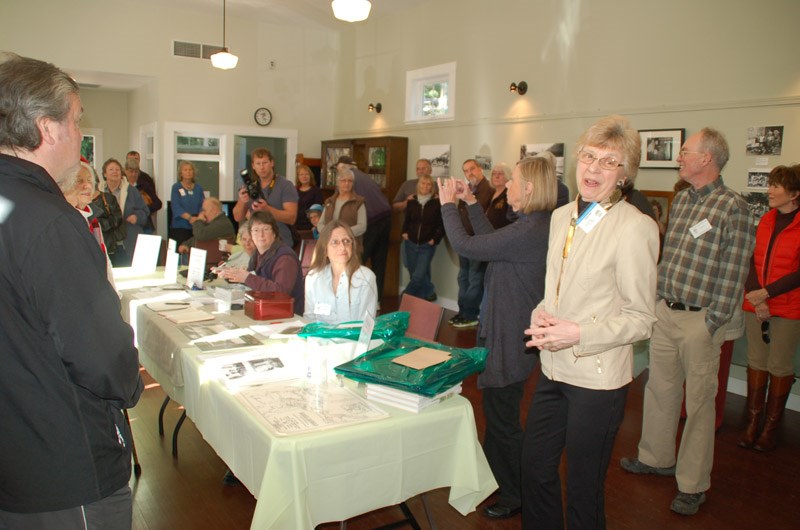 Elaine Park, president of the Pender Harbour Living Heritage Society (third front right), addresses residents at an open house last Saturday to celebrate the re-opening of Sarah Wray Heritage Hall
