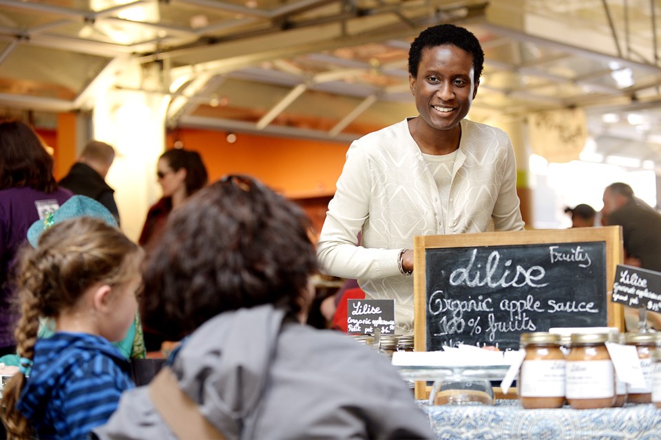 Shoppers check out Lilise's organic applesauce at the Royal City Farmers Market.