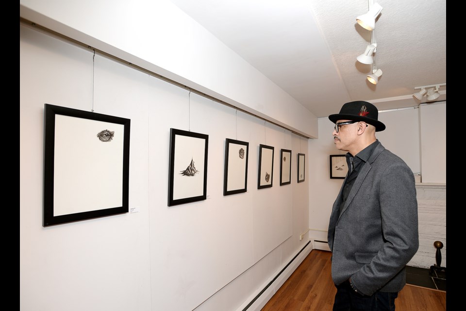 Michael Louw checks out the work at Drawn, the new exhibition at Deer Lake Gallery.