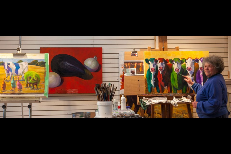 The Lucich home includes a 500-square foot studio where Julia recently completed a herd of cows for a Calgary art lover. At left is a painting of eggplant and onions, and one of pig, cow and ducks, called Party Quackers with Ham and Cheese.