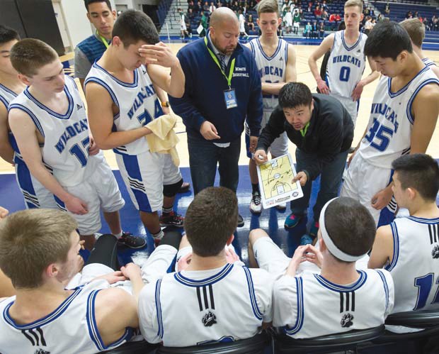 McMath Wildcats coach Bik Chatha talks tactics during the provincial championships with his players, who he feels will benefit from this year's experience