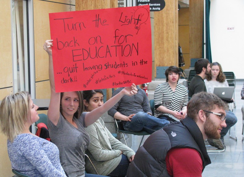 One student silently voiced her opinion as her poster spoke for her during the 24-hour sit in held at UNBC's administration building, which began Wednesday morning.