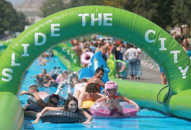 Salt Lake City residents slide down a 1,000-foot water slide. Slide the City is coming to North Vancouver on Aug. 22.