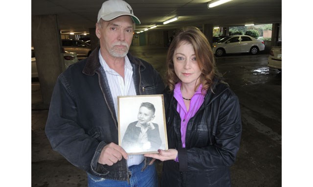 Pat Kelly, left, and his wife, Debbie Gould, with a picture of Kelly as a young boy. It's now the only family heirloom he has left after the theft.