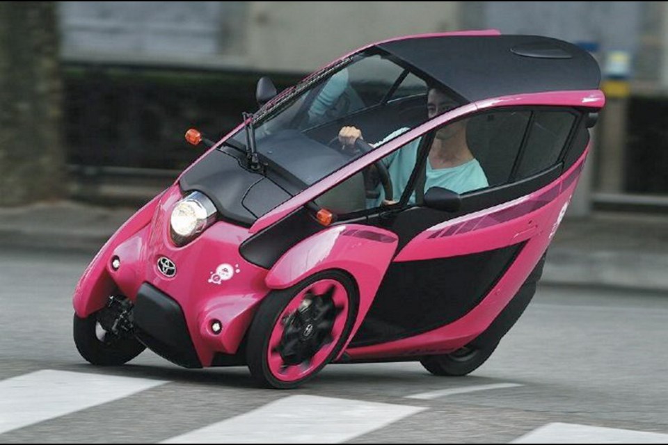 The three-wheeled electric car called i-Road carries two people, one behind the other, and leans into curves the way a motorcycle does.