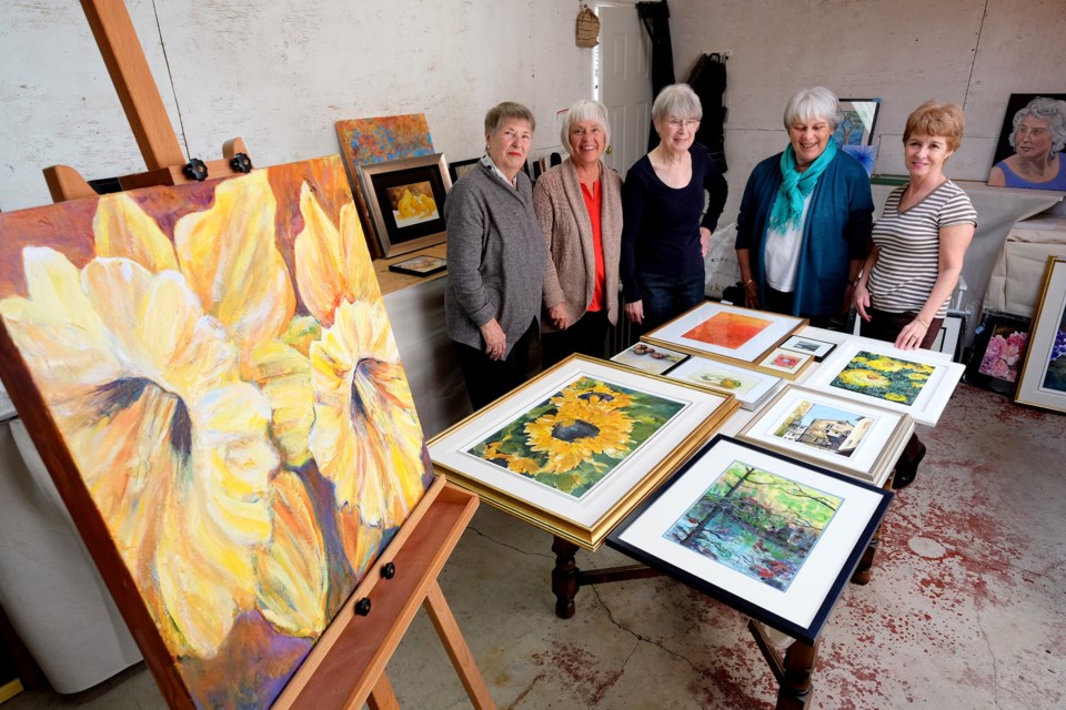 Art in bloom: From left: Wilma Cook, Dianne Yard, Sheila Chowdhury, Pat Sexsmith and Kathryn Newell are inviting the community to enjoy their artwork at their annual spring art show. The Gamma Garage art show is open Saturday and Sunday, April 11 and 12 from noon to 5 p.m. in the studio at 232 North Gamma Ave.