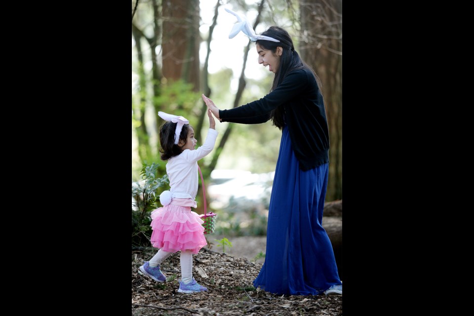 Two-year-old Dua Kazmi of Surrey hunts for Easter eggs with the help of big sister Aliya, 16.