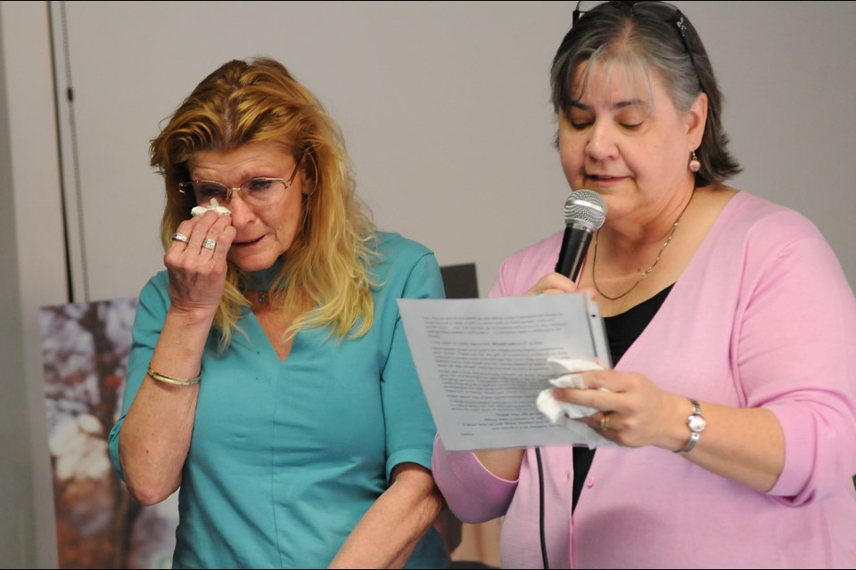 Danny Maloney’s sister, Debby, was comforted by friend Janice McTaggart at a ceremony Tuesday to remember her brother, who died of lung disease last month. Photo Dan Toulgoet