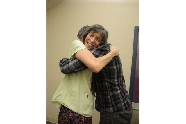 Richmond Cuddle Party facilitator Karin Whittaker hugs it out with Richmond News reporter Alan Campbell