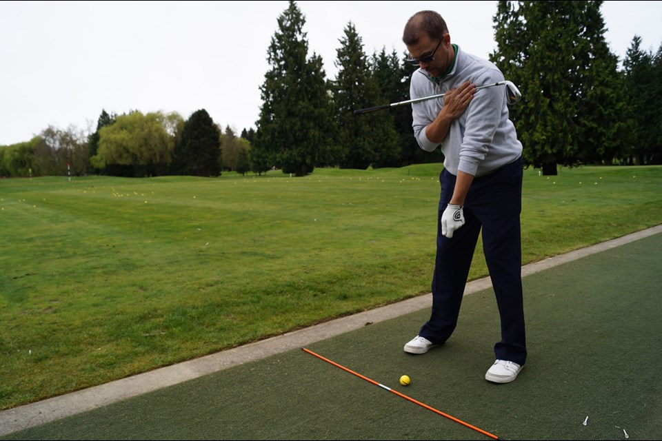 Richmond Country Club's head instructor Mark Strong demonstrates a properly aligned setup, which is the foundation of a good ball strike. April , 2015
