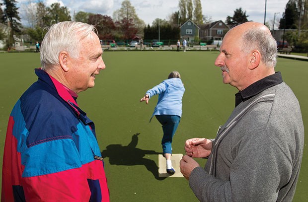 Both local lawn bowling clubs held open houses last weekend to introduce newcomers to the sport. Sandy Watson gets instruction from the Ladner Lawn Bowling Club’s Cliff Caprani as his wife Mary tries a shot.