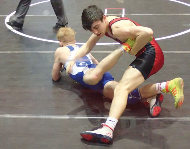 James Sutherland of the North Shore’s Capilano Wrestling Club goes for a grab against Alberta’s Cristoff Coles in the 63-kilogram juvenile boys semifinals at the Cadet/Juvenile Canadian Championships held April 9-12 in Fredericton, N.B. Sutherland went on to win silver. photo supplied