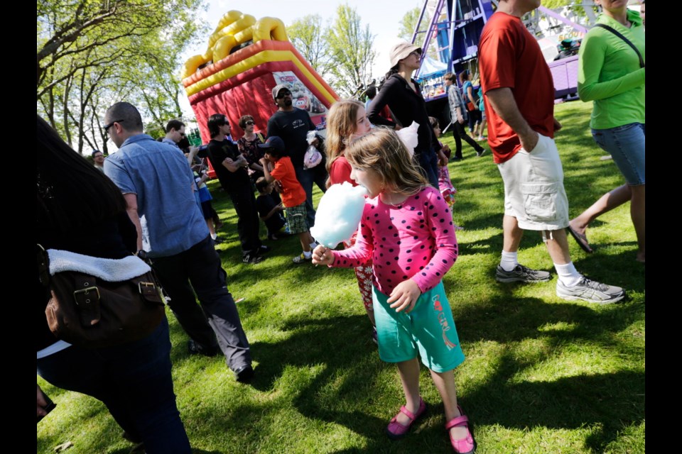 Seven-year-old Kristina Zatylny enjoys some cotton candy at the Oak Bay Tea Party on Saturday.