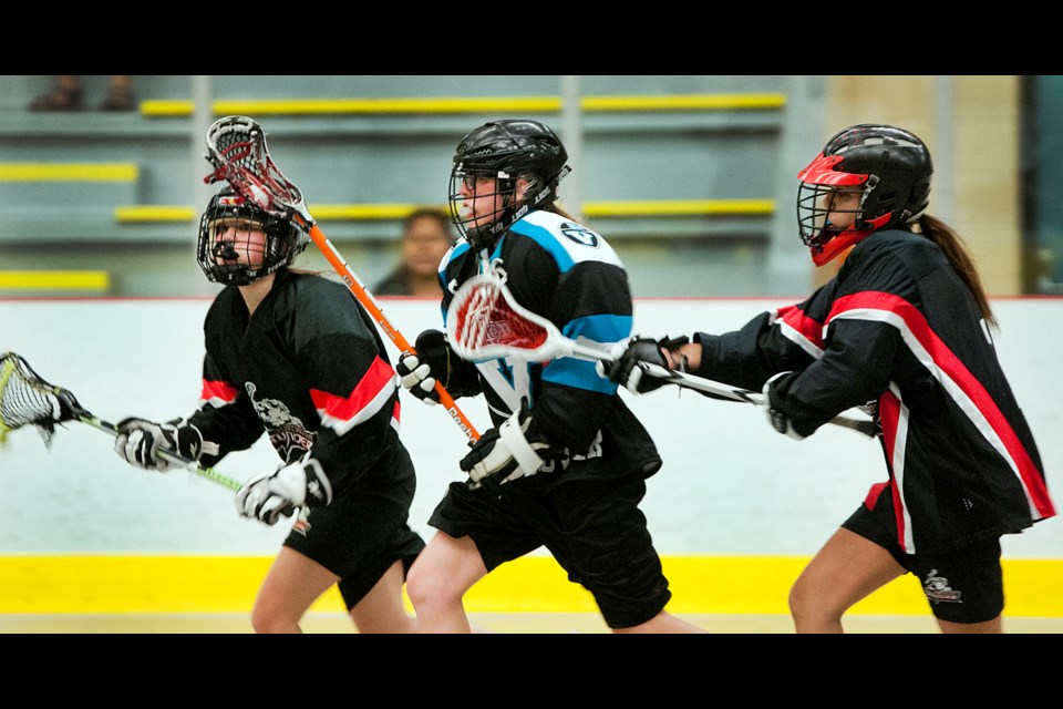 Katherine Ewanchook (No. 8) breaks through the Thunder defence during an early season game for the Vancouver Burrards bantam girls box lacrosse team at the Port Moody Rec Centre April 26, 2015. Photo Chung Chow