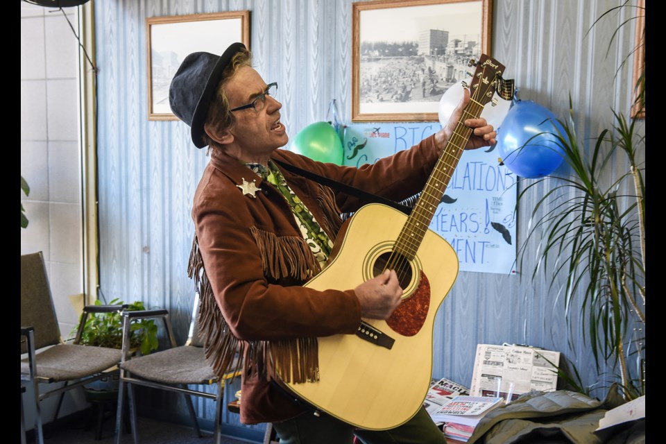 Paul Wickett worked with Rick Caulfied for 10 years. He returned to Kitsilano Barbers Saturday to pay tribute to his friend and sing him a song. Photo Rebecca Blissett