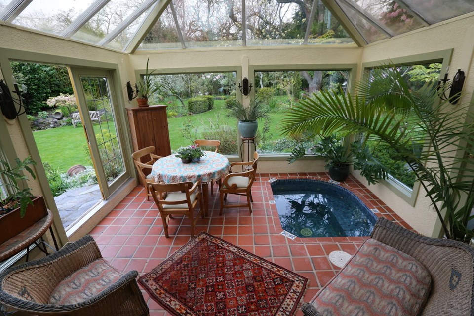 A hot tub in the glass sunroom is ideal for relaxing or reflecting the outdoor scene. Terracotta tiles add year-round visual warmth.