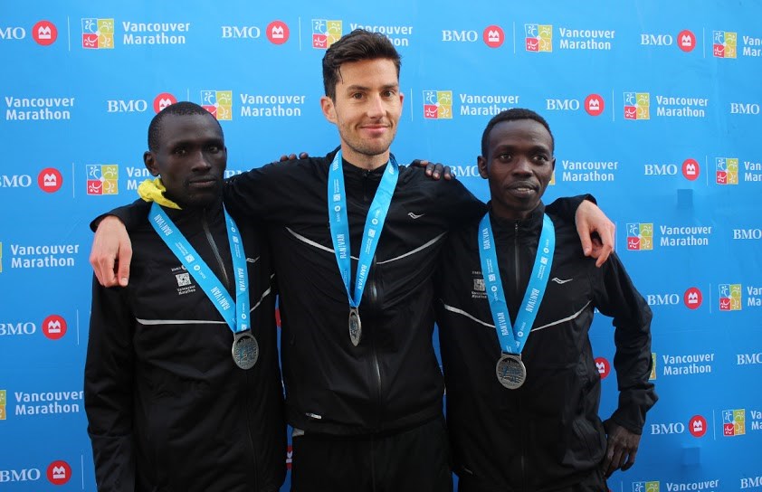 BMO Vancouver Half-Marathon winner Rob Watson is flanked by Willy Kimosop and Leonard Koech on May 3, 2015. Photo Rob Kruyt