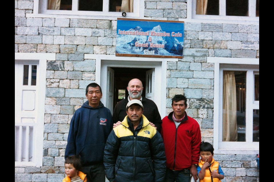 Help from abroad: Retired Burnaby fire captain Eoin White (centre), with one of his ‘sons,’ Kami Nurba Sherpa, at far left. Kami’s tea house, in the background, was damaged during the quake.