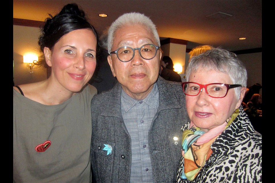 Photo of the authors and illustrator of the book Dolphin SOS. From left to right stand illustrator Julie Flett, author Roy Miki, and author Slavia Miki.