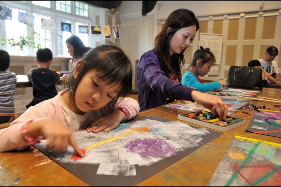 From left, Bella Hung, 5, her mom Janice Chen and sister Angie Hung, 8 take part in a Mother’s Day studio activity at Burnaby Art Gallery.