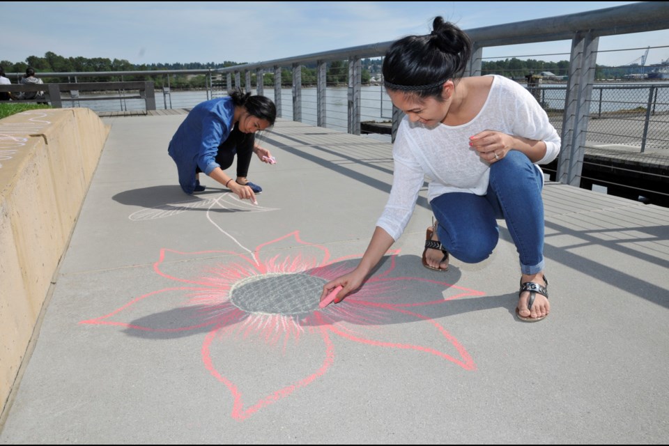 050915 - New Westminster, BC
Chung Chow photo
Scenes at Westminster Pier Park
Sisters Leah (white) and Kathleen Laureeno decided to decorate with a chalk lotus.