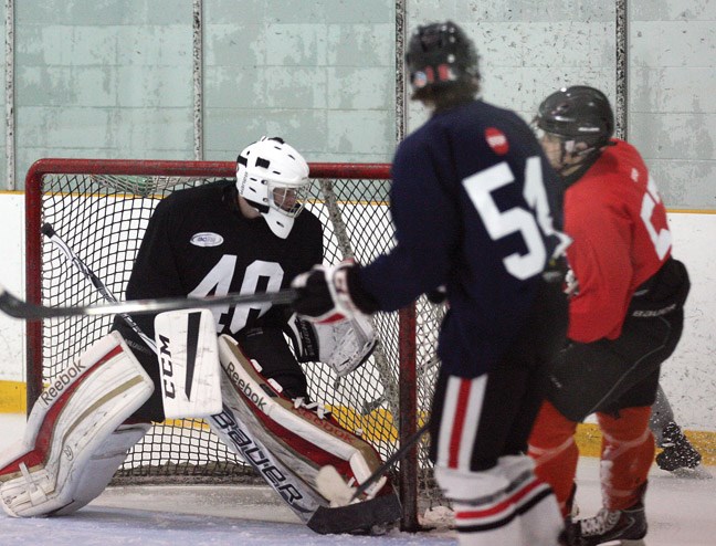 Kregg Sterritt, goalie for Team Blue tracks the puck in the corner during Sunday afternoons final instrasquad game of the Cariboo Cougars spring prospects camp. The camps featured 100 major midget players from Northern BC.
