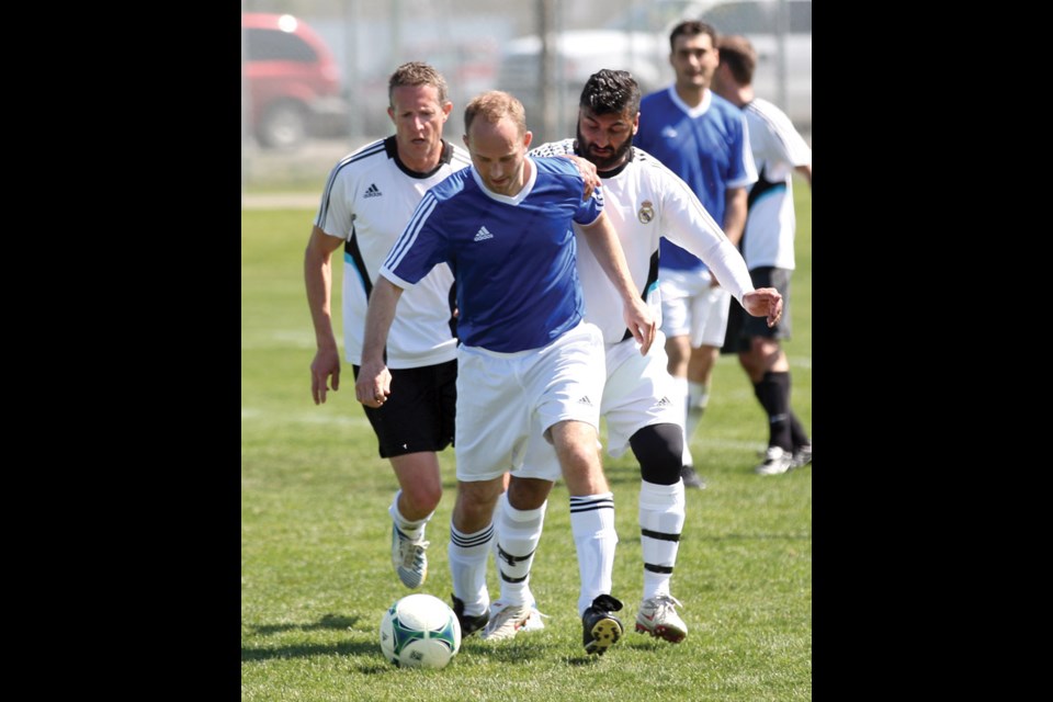 With two players after him, Tyson von den Steinen of Team Assante tries to maintain control of the ball Sunday afternoon during the NCSSL icebreaker tournament.