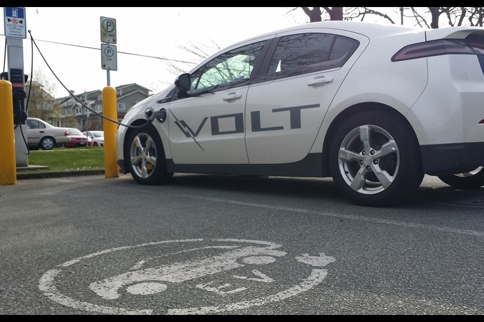 An electric vehicle is charged at Steveston Community Centre. The City of Richmond is considering consulting with businesses about installing charging stations in commercial areas. So far only City of Richmond properties have charging stations. May, 2015.