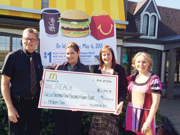 Steve Krawchuk (left), owner of the Ladner and Tsawwassen McDonald’s locations, and Holly Sorley, manager of the Tsawwassen McDonald’s, present a cheque to Karen Horn and Barbara Wallick of Reach.