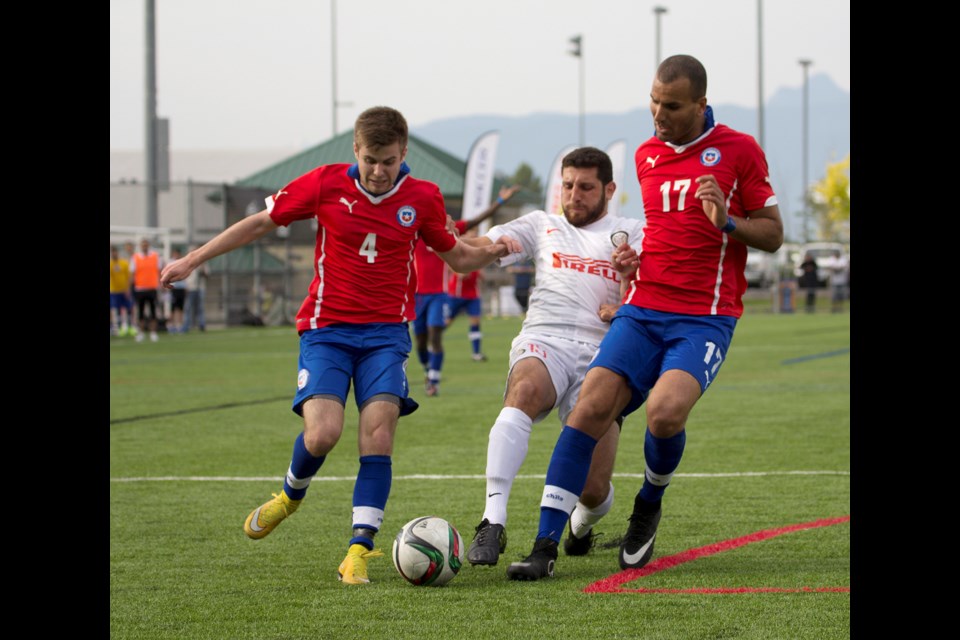 Andre Hearth for Vancouver's Inter soccer club is flanked by two Estrella de Chile players during a 3-1 loss in the Vancouver Metro Soccer League men's 'A' Provincial Cup final in Langley May 10, 2015. Photos Monique Lamoureux / bcsoccerweb.com