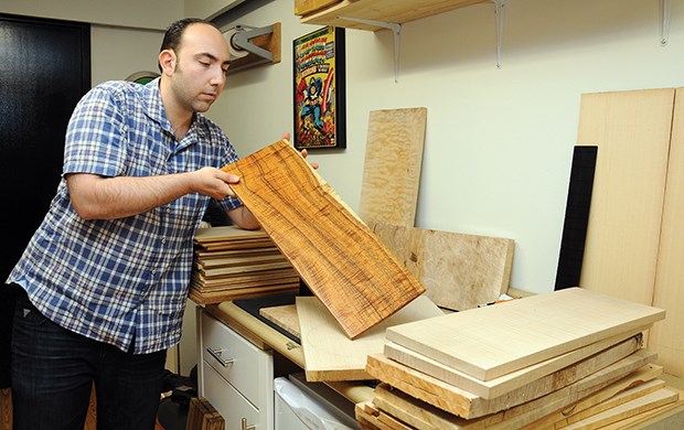 Prestige Guitars owner Mike Kurkdjian checks over some wood in the assembly room.