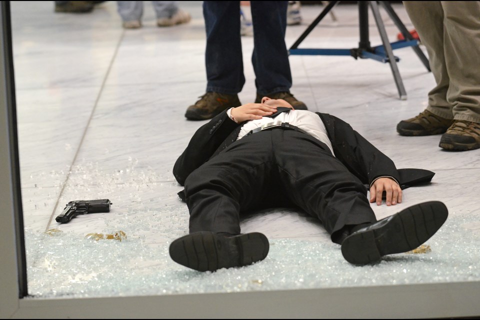 An actor lies in the Anvil Centre lobby in New Westminster during the filming of Darc.